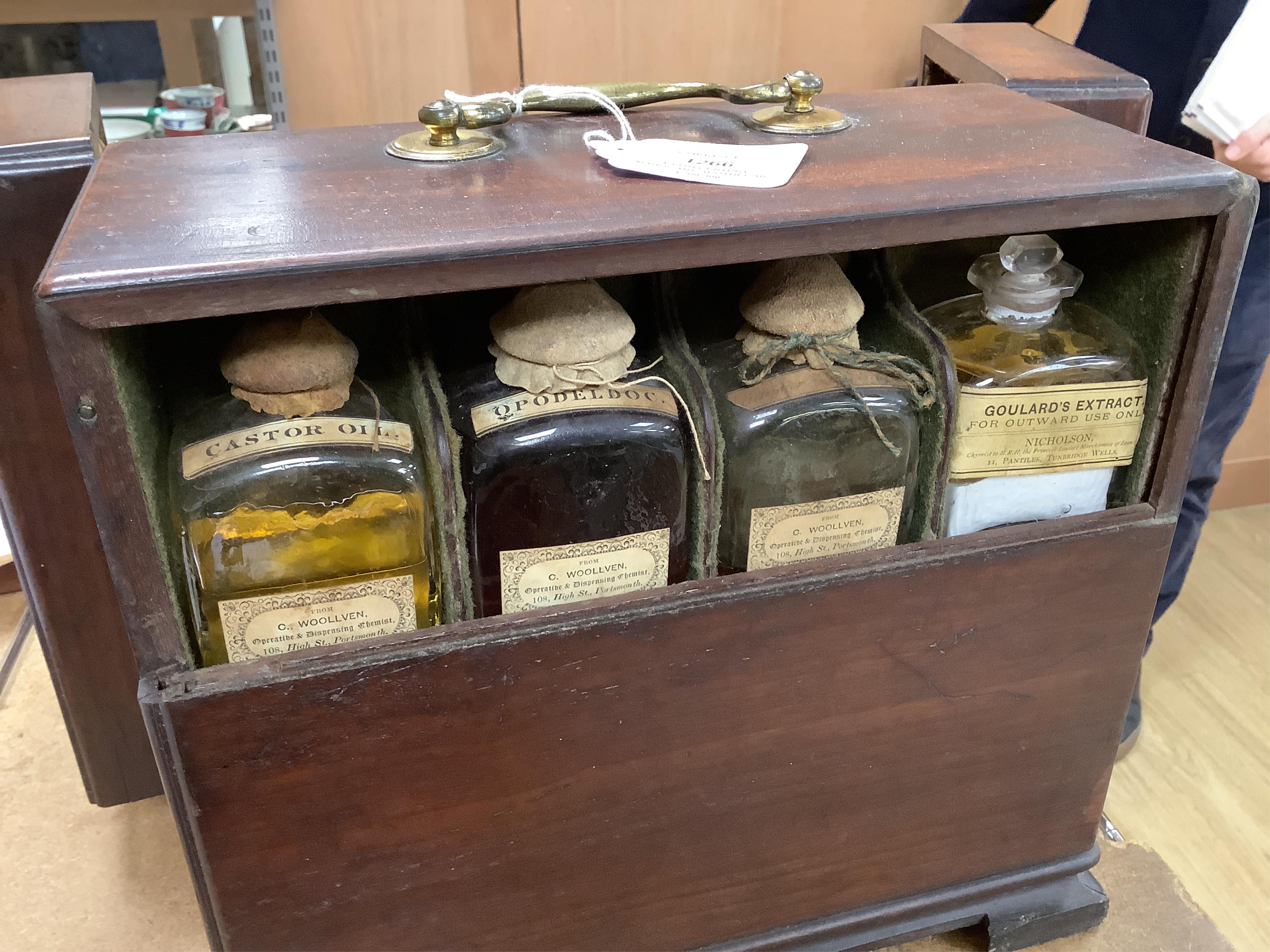 A 19th century mahogany apothecary cabinet, containing 20 bottles of various medicinal compounds and poisons, some sealed, all with paper labels, mainly for ‘C. Woollven, Operative & Dispensing Chemist, 108, High Street,